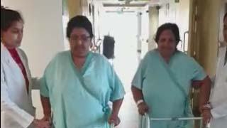Two patients weighting more than 100 kg walking next day after Robotic computer assisted knee replacements.